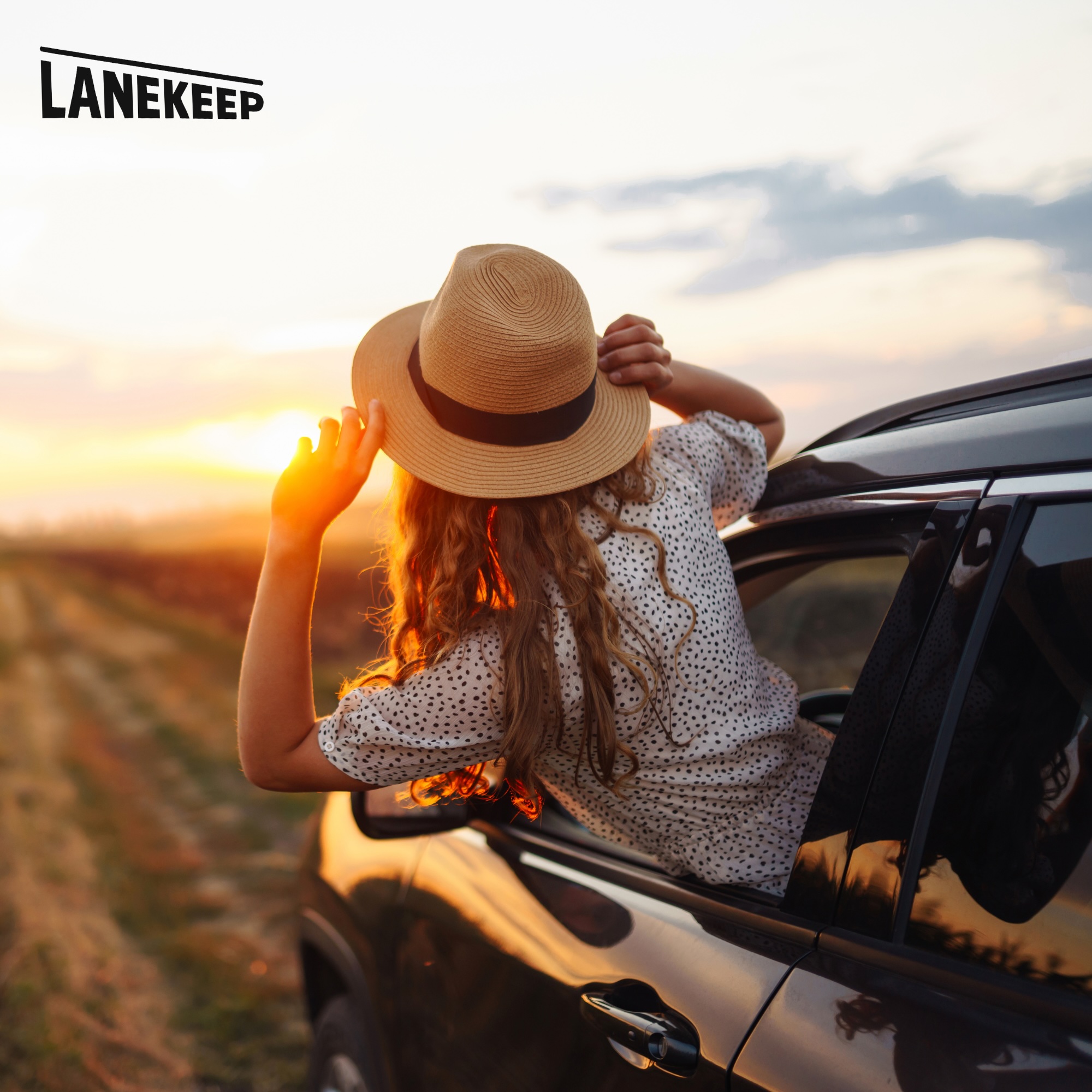Woman enjoying car ride at sunset